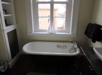 A Downtown Frederick bathroom remodel in a historic home that features a vessel bowl sink and clawfoot tub that fit the style of the house