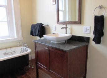 A Downtown Frederick bathroom remodel in a historic home that features a vessel bowl sink and clawfoot tub that fit the style of the house
