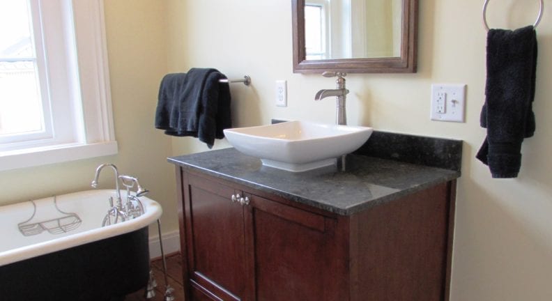 A Downtown Frederick bathroom remodel in a historic home that features a vessel bowl sink and clawfoot tub that fit the style of the house