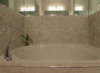 Condo bathroom remodels in downtown Frederick with custom shower enclosures and stand alone tub, think what they may look like in your house